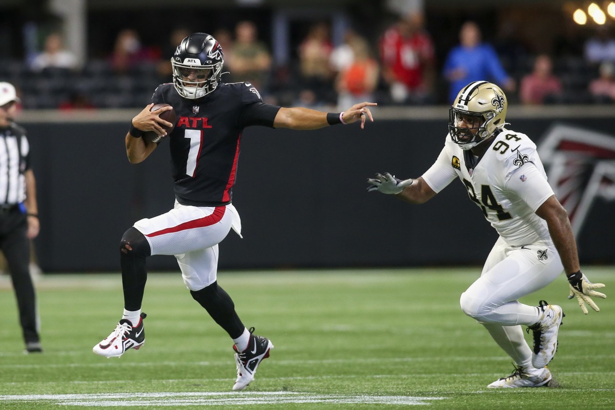 Sep 11, 2022; Atlanta Falcons quarterback Marcus Mariota (1) runs past New Orleans Saints defensive end Cameron Jordan (94). Mandatory Credit: Brett Davis-USA TODAY Sports